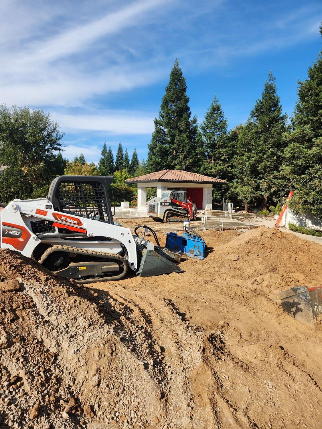 Skid steer removing an old driveway