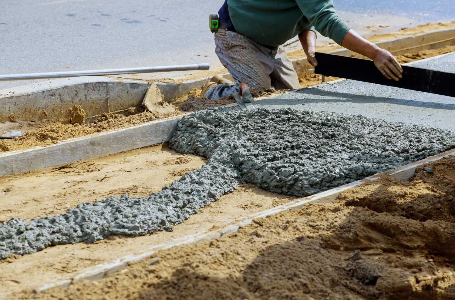 Fresh concrete being placed between forms