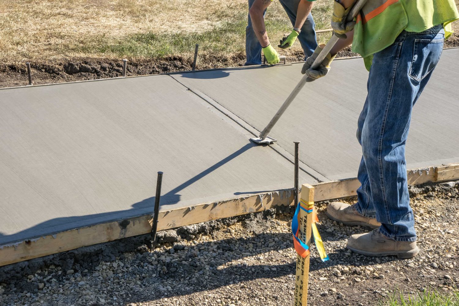 Big Hammer Concrete crew screeding fresh concrete