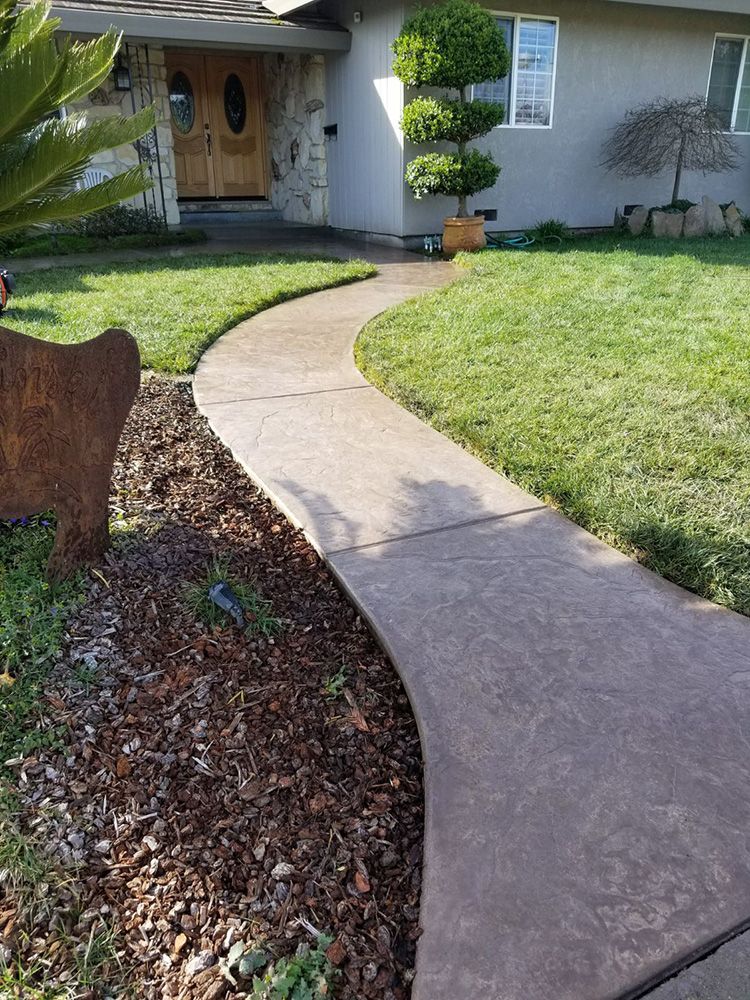 Curved concrete walkway to a front door